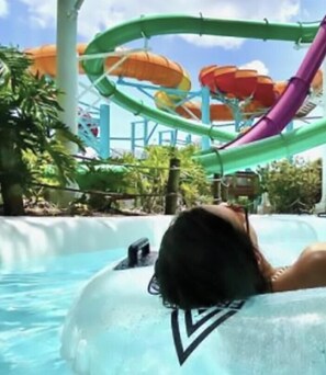 A water park with a water slide and a pool.