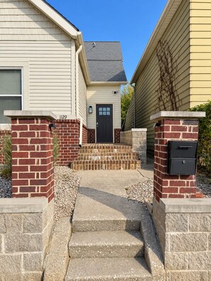 A residential property with a front entrance, a mailbox, and a number '1129' on the wall. - Walk to Lucas Oil Stadium - Clean 4BR Home (Indianapolis)