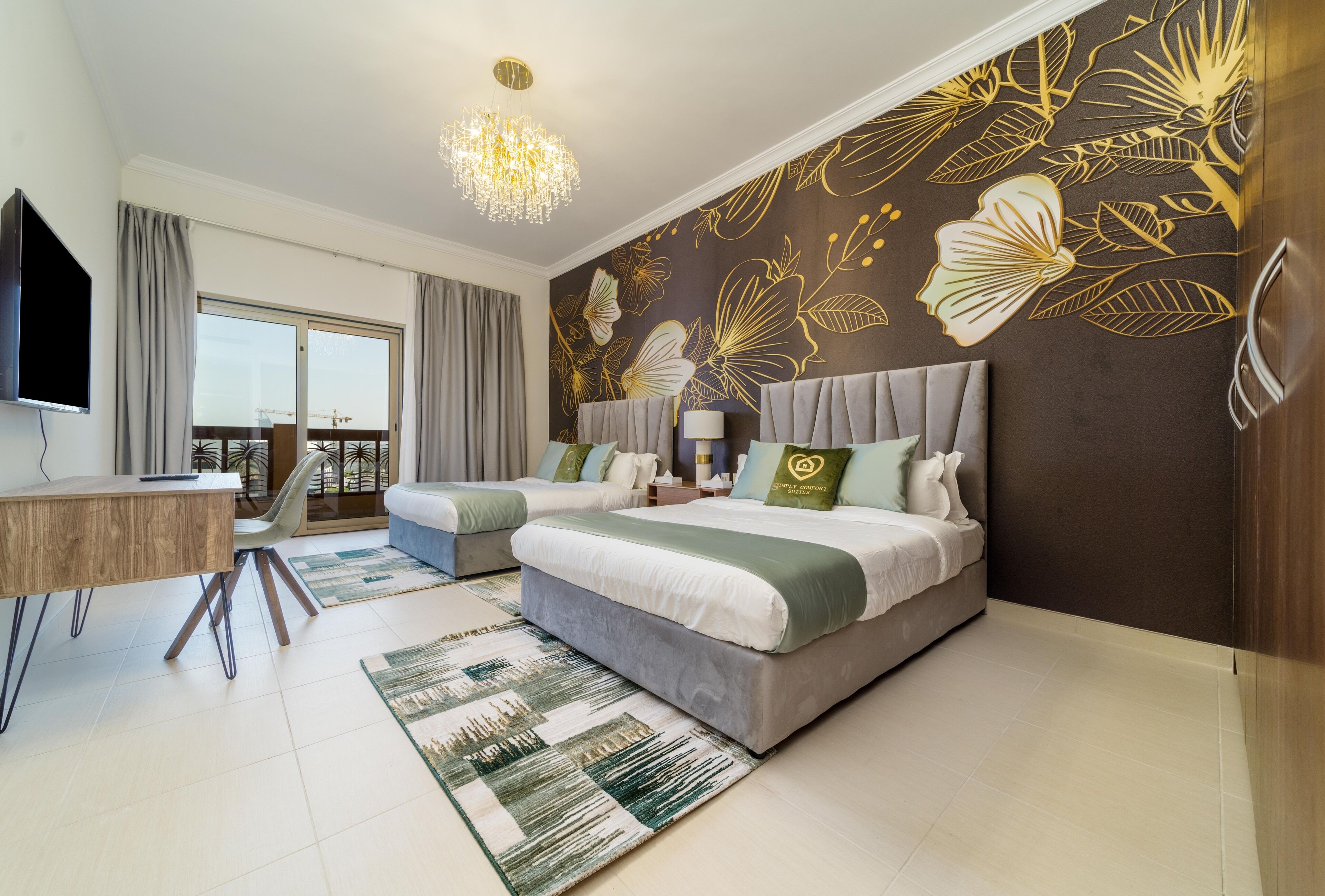 A modern bedroom with a large bed, two bedside tables, a desk, and a balcony view.