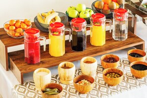 A breakfast buffet with various fruits, beverages, and condiments. - Grand Nur (Tashkent)