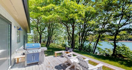 Water-view retreat with beach access, deck, grill, EV charger & lawn games