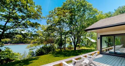 Water-view retreat with beach access, deck, grill, EV charger & lawn games