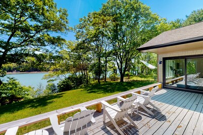 Water-view retreat with beach access, deck, grill, EV charger & lawn games