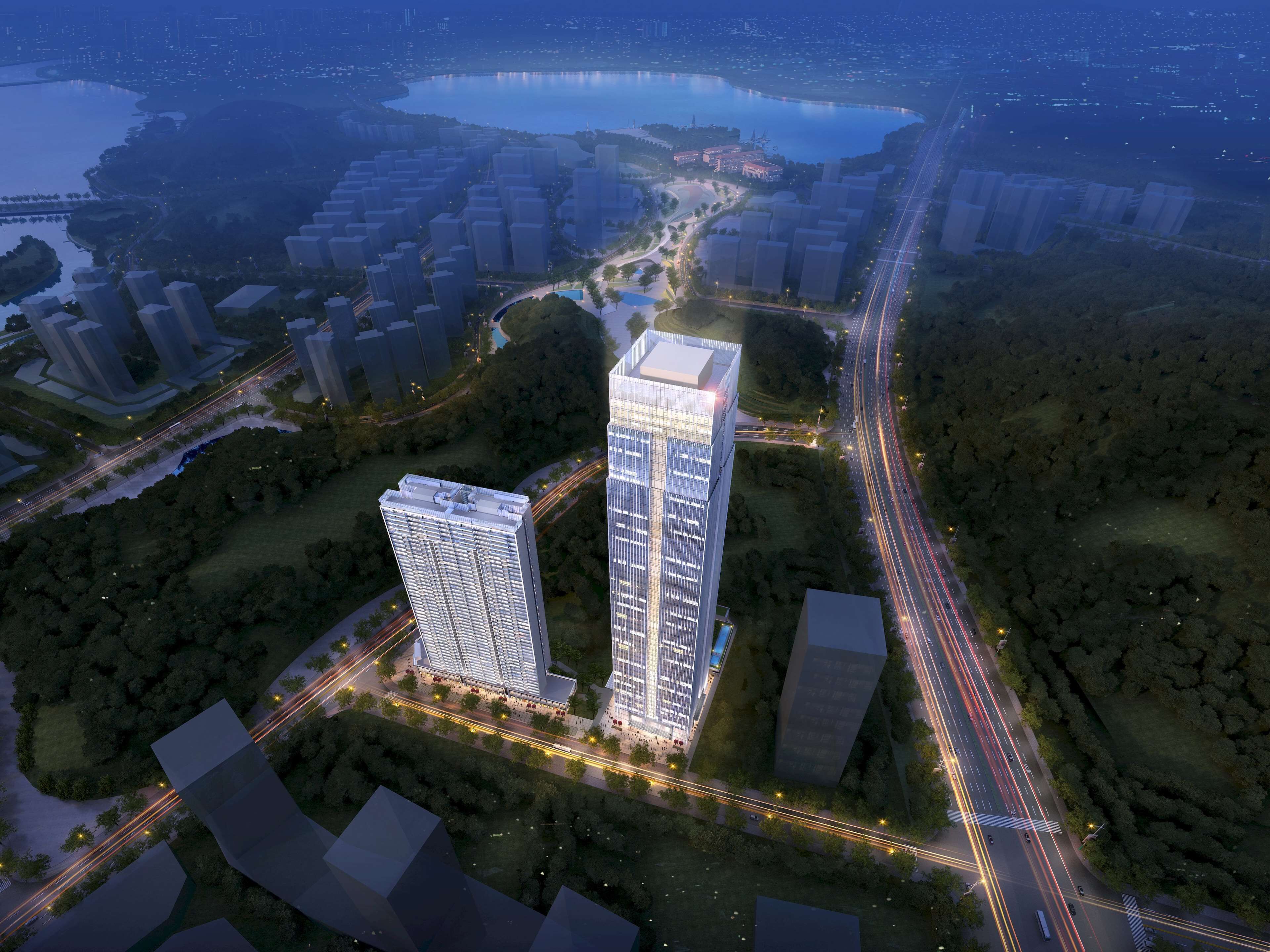 An aerial view of a modern urban area with high-rise buildings, roads, and a body of water.