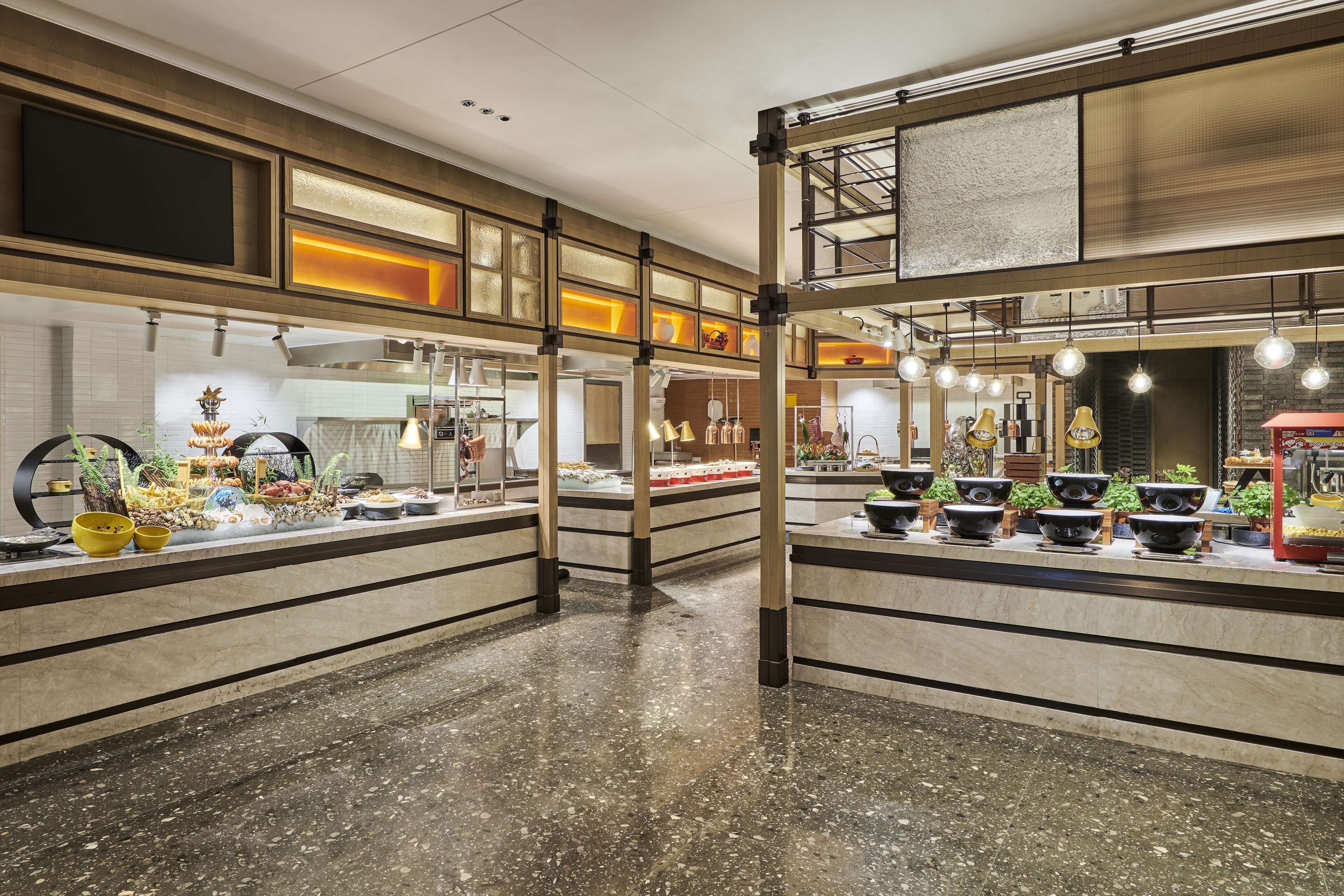 A spacious, modern kitchen with high ceilings and a mezzanine level.