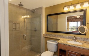 Enjoy a refreshing shower in the bathroom with a glass-enclosed shower area, a toilet, and a sink.