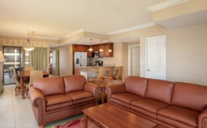 Cozy living space with a leather sofa, dining area, and kitchenette.