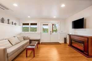 TV, fireplace - Bayfront apartment with private patio, beach access, water views, AC & W/D (Port Townsend)