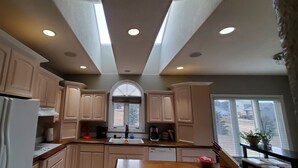 A kitchen with light wood cabinets, a white refrigerator, and a skylight. - Luxury, Private,Relaxation with beautiful quiet area in the heart of the hills (Rapid City)