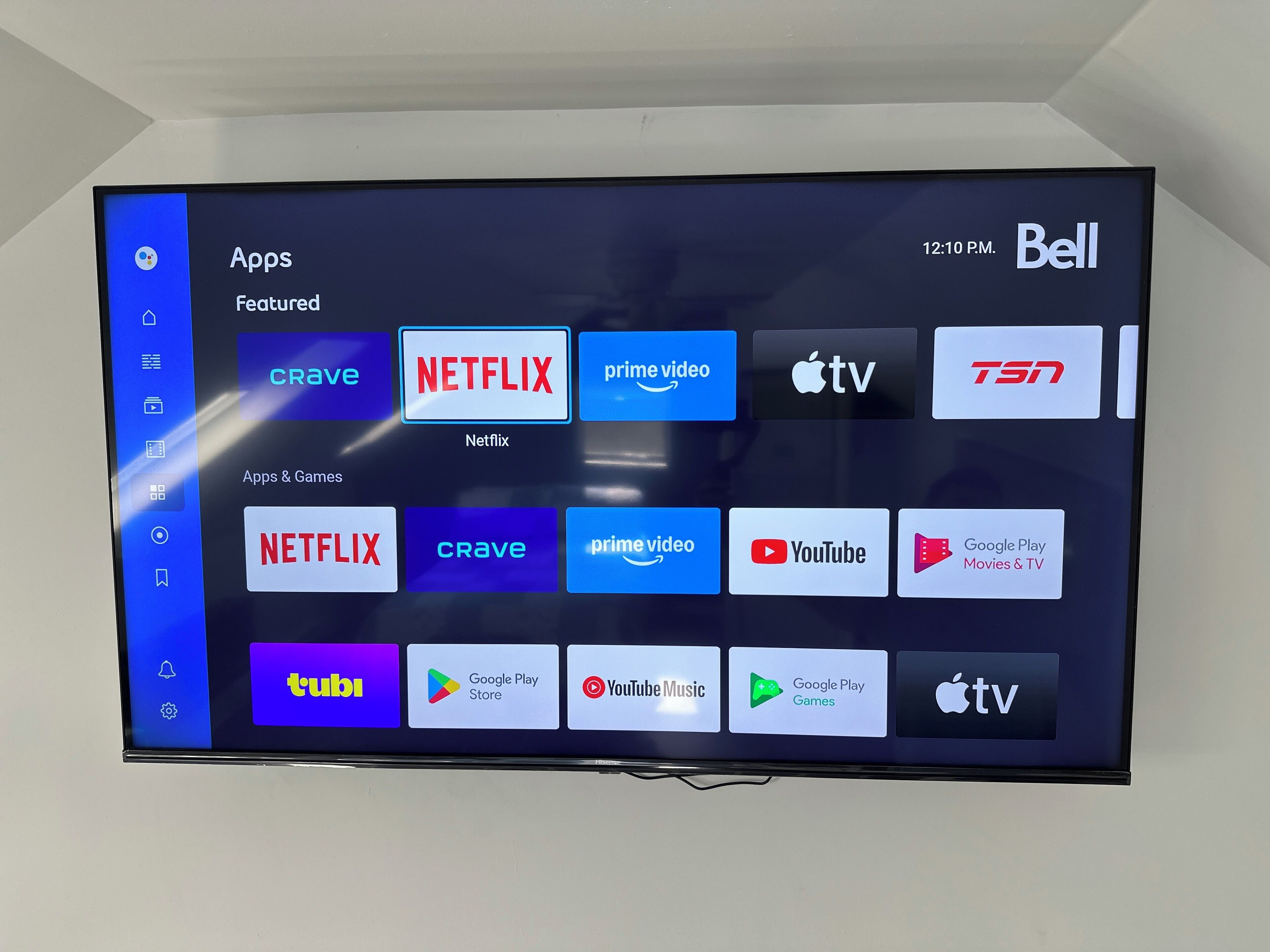A flat-screen TV displaying a variety of app icons, including Netflix, Prime Video, and YouTube.