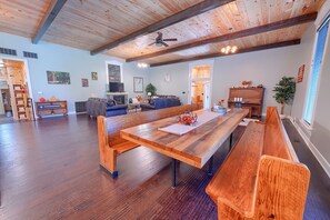A spacious living area with a long wooden bench, a fireplace, and a piano. - Chapel Valley Lodge - Unique, in the Hocking Hills (Logan)