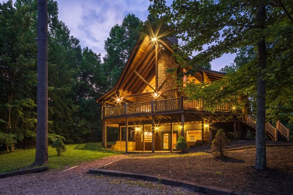 A lodge with a stone facade, wooden deck, and a staircase leading to the entrance. - Timber Ridge Lodge - 5-BR, w/King Suite - Hocking (Logan)