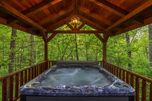 A hot tub in a wooden gazebo surrounded by a forest. - Hunter's Retreat - Cozy Cabin, near Old Man's Cave (Logan)