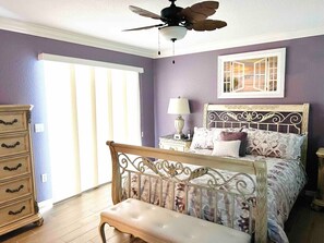 A bedroom with a bed, a nightstand, a dresser, and a ceiling fan. - Covered Heated Pool Included! Only 12 Min Drive to Beach! (Englewood)