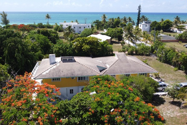 Yellow house in the foreground, just 200 meter walk to the beach.