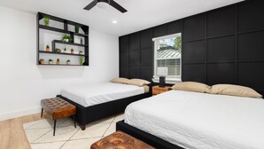 A modern bedroom with two beds, a ceiling fan, a wall-mounted plant shelf, and a window with blinds. - Listen Linda, 5 Bedroom Home Near Bishop Arts (Dallas)