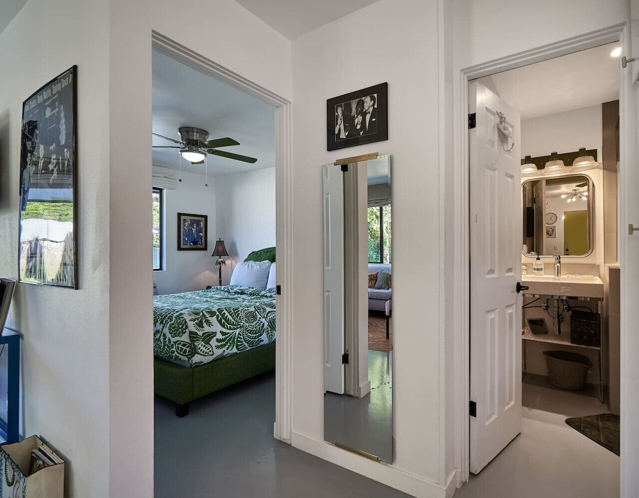 A bedroom with a bed, a ceiling fan, and a window.