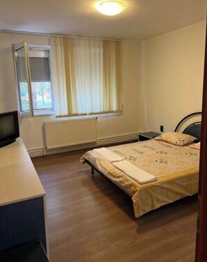 Cozy retreat with a single bed, desk, and chair, offering a quiet space to work or rest.