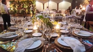 A dining area with tables set for a formal event, complete with candles, glassware, and floral centerpieces. - Hotel Danini (Teziutlan)