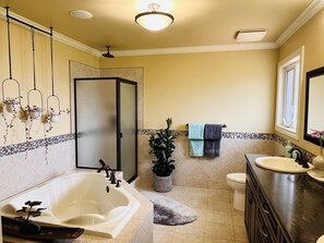 A bathroom with a bathtub, toilet, sink, and a shower. - Magical Farm Villa with Heated Salt Water Pool (Duncan)