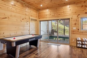 Enjoy a leisurely game of pool in this inviting room, featuring a Brunswick pool table and access to the outdoor pool.