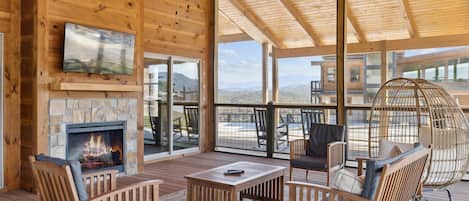Relax in a tranquil setting with a fireplace and scenic mountain views.