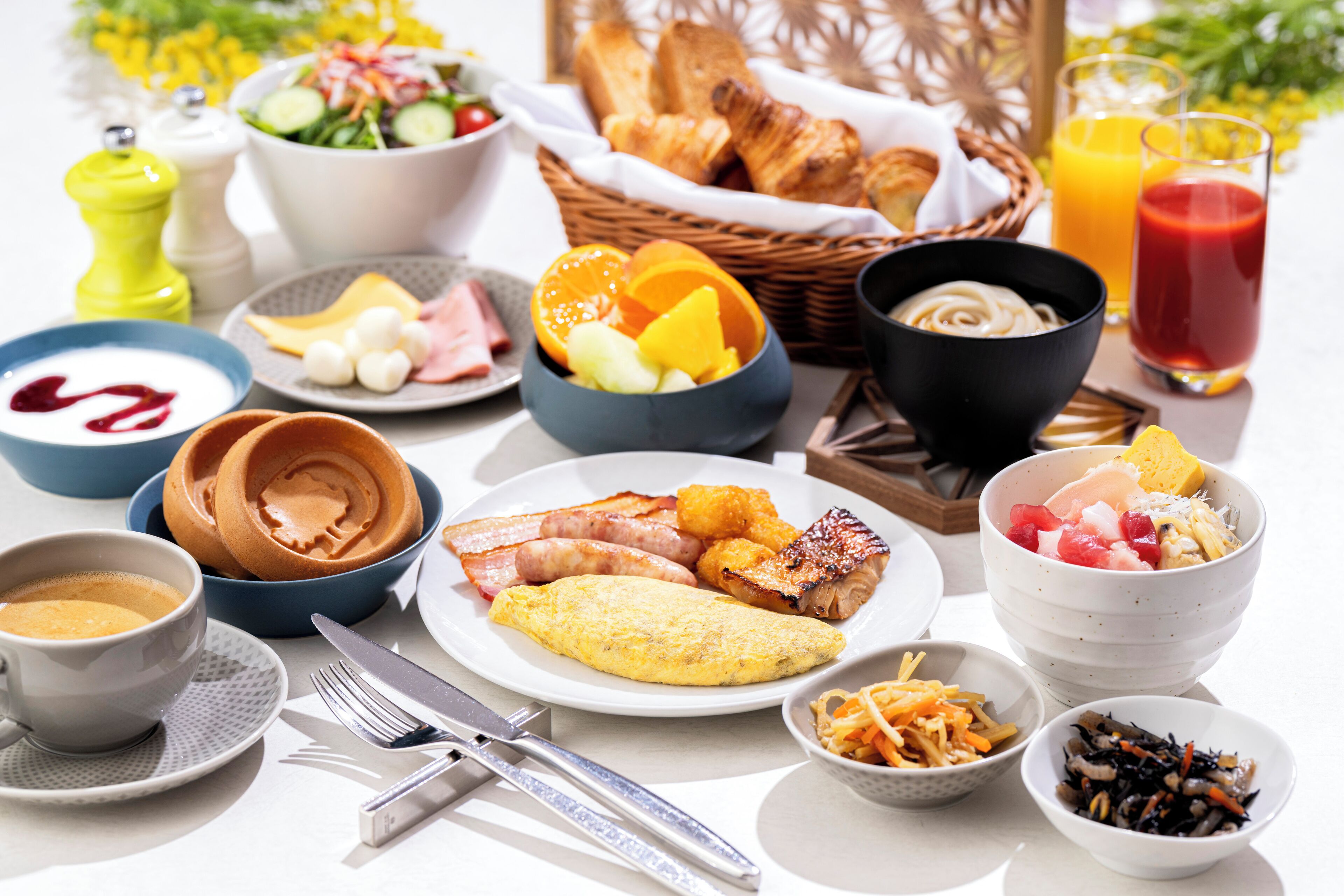A breakfast buffet with various dishes, including eggs, bacon, and fruit.