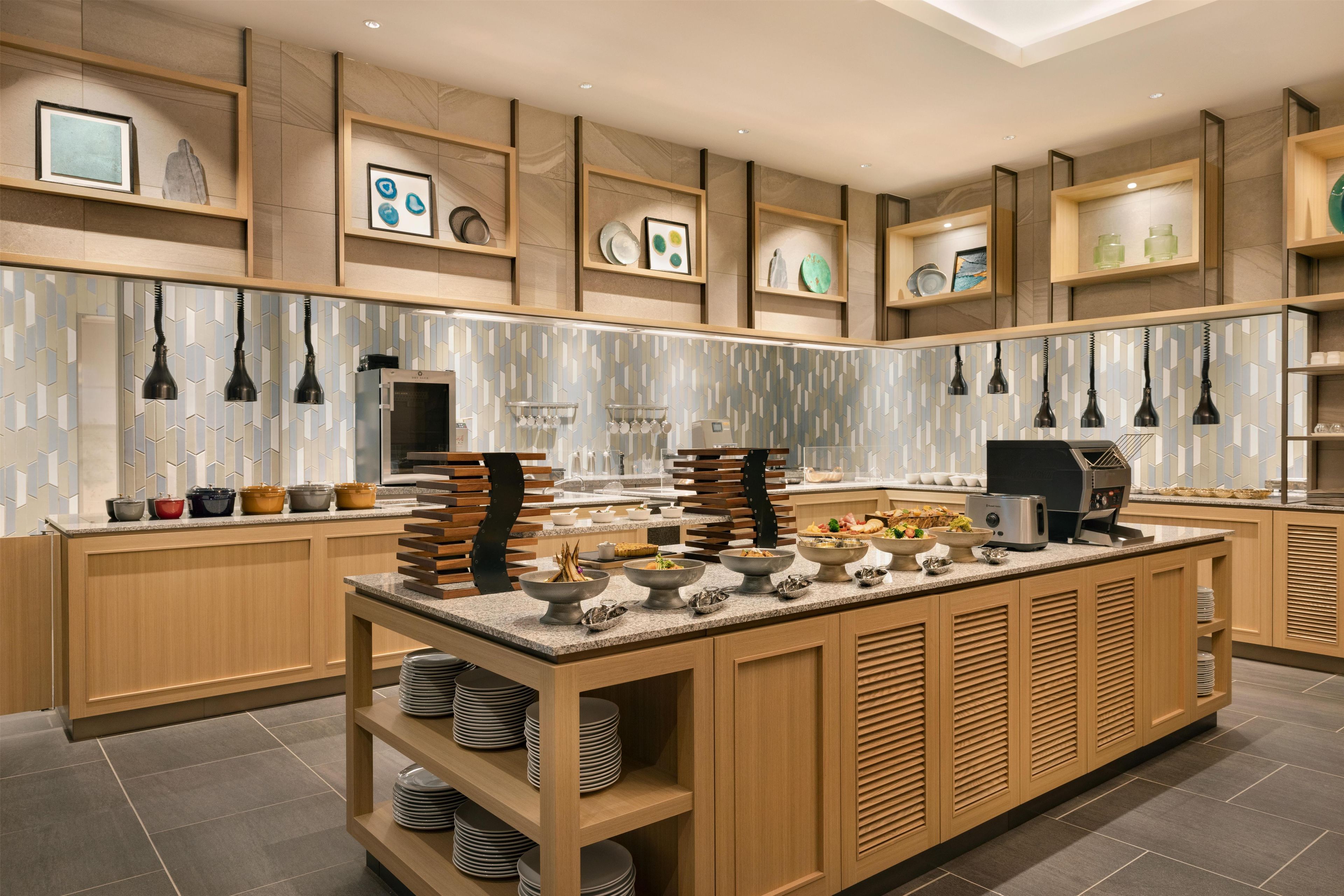 A modern kitchen with a central island, wooden cabinets, and a tiled backsplash.