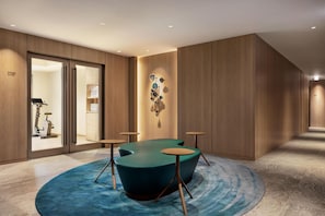 A modern hotel room with a large window, a blue carpet, and a wall-mounted decorative piece. - DoubleTree by Hilton Toyama (Toyama)