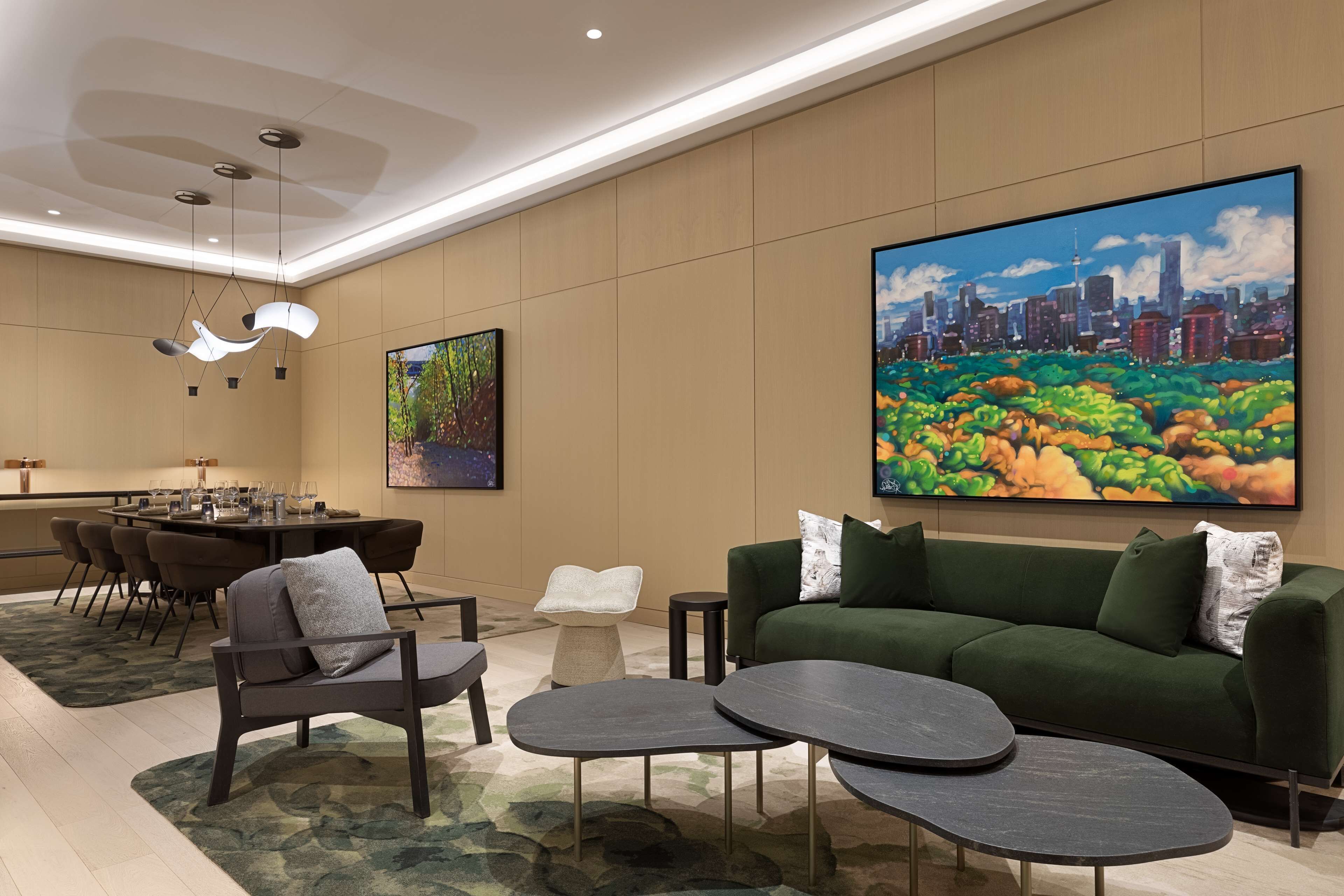 A modern hotel lobby with a dining area, a green sofa, and a large cityscape painting.