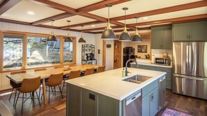 A modern kitchen with a central island, stainless steel appliances, and pendant lighting. - Dollar Lake Retreat: Super Clean, Chef's Kitchen, Hot Tub + Amazing Sunsets (Eagle River)