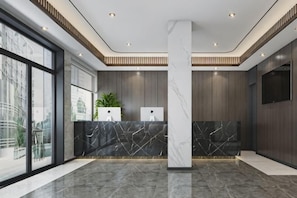 A modern reception area with a marble counter, large windows, and a central pillar. - GYA Hotel (Shanghai Railway Station) (Shanghai)