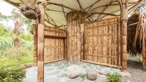A traditional bamboo structure with a thatched roof, a stone floor, and a natural surrounding. - Romantic Cabana with view (Armenia)