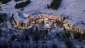 A large lodge with multiple buildings, a ski lift, and a parking area with cars. - Fairfield Inn & Suites By Marriott North Conway (North Conway)