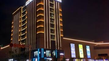 A multi-story hotel with illuminated vertical lines and signage.