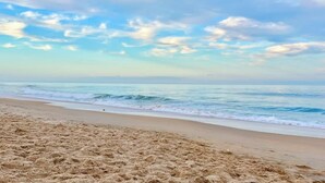 A beach with a sandy shore and ocean waves. - Luxury Beach House, Private Salt Pool. Walk to the Beach (Palm Coast)