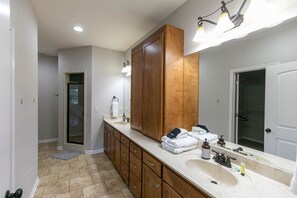 A modern bathroom with a large vanity, a double sink, and a walk-in shower. - Sleeps 14 on a Duck River ranch: 4 en suite bedrooms, patio, fishing, horses (Normandy)
