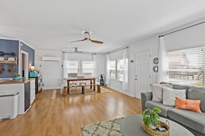 Relax in this open-plan living space with a kitchen, dining area, and comfortable seating.