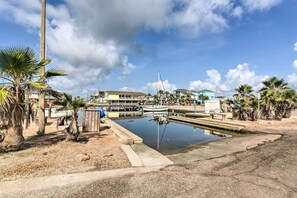 Stunning marina views with boats docked and palm trees surrounding the calm water.