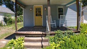 A single-story house with a front porch, a front door, and a small window. - Harper, Two Bedroom House in Historic Loveland (Loveland)