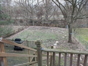 A wooden deck with a metal railing, a bench, and a tree in the background. - Ohio Ave, 3 bed house, Historic Downtown Loveland (Loveland)