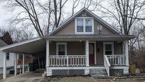 A single-story house with a front porch, a small garage, and a red door. - Ohio Ave, 3 bed house, Historic Downtown Loveland (Loveland)