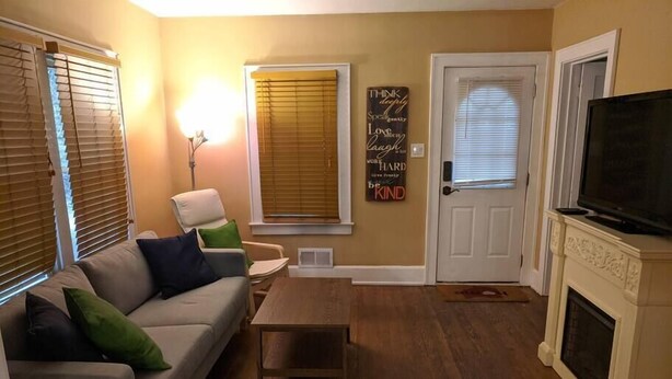 A living room with a sofa, a coffee table, a fireplace, and a television. - Ohio Ave, 3 bed house, Historic Downtown Loveland (Loveland)