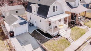 A two-story house with a garage, a covered porch, and a small backyard. - Ridgeway, 2 Bedroom House near Xavier, Downtown (Cincinnati)