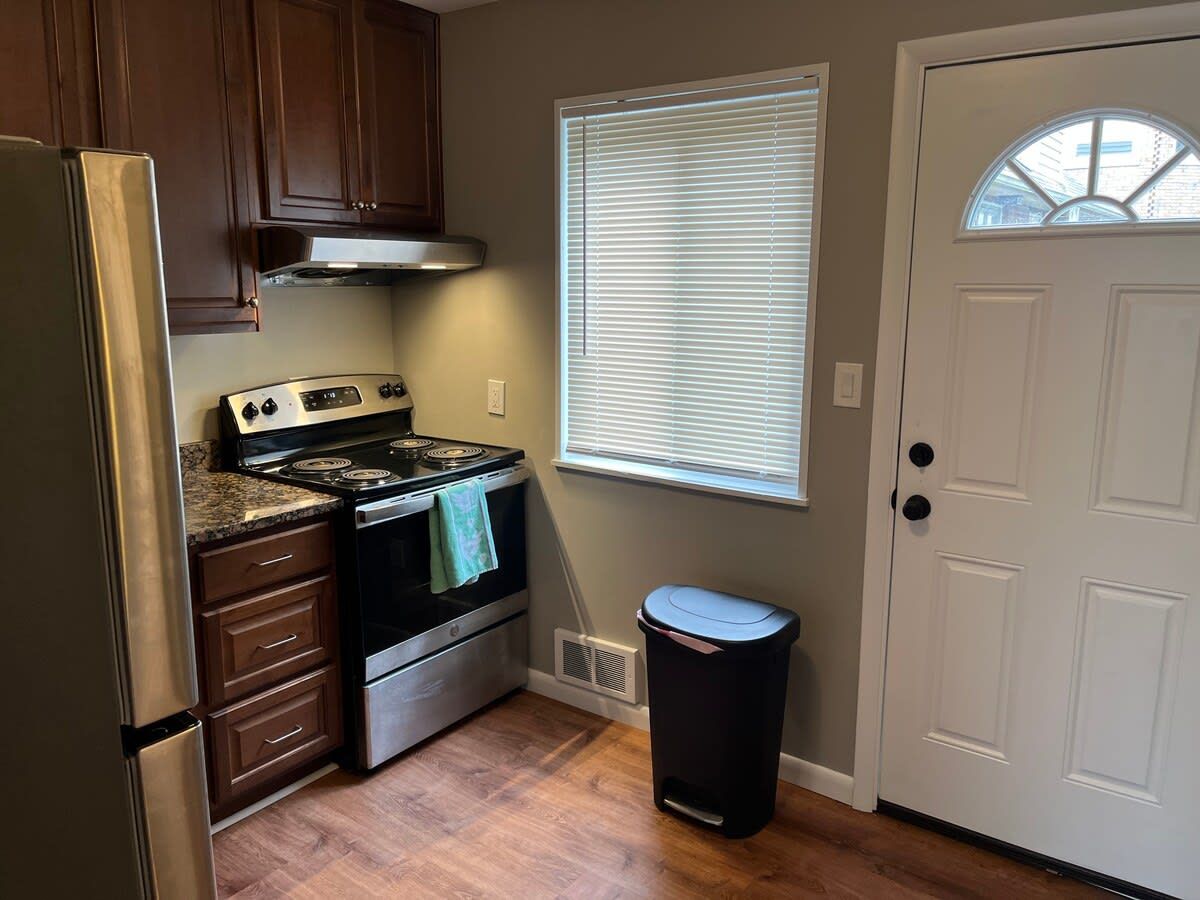 A compact kitchen with a stove, oven, and refrigerator.