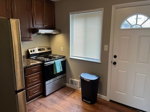 A compact kitchen with a stove, oven, and refrigerator.