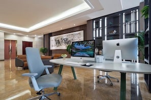 A modern office with a desk, computer, and seating area. - Pegasus Hotel (Zhaosu)