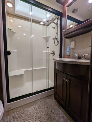 Shower, hair dryer, towels, soap