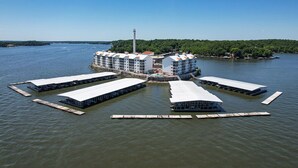 A waterfront hotel with multiple buildings connected by walkways over water. - Island Life! Amazing Balcony-Views-Pool and Patio (Rocky Mount)