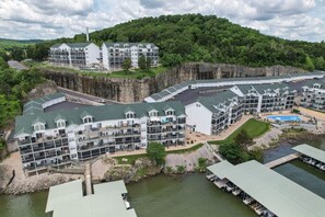 A multi-story hotel with a dock and a pool area.